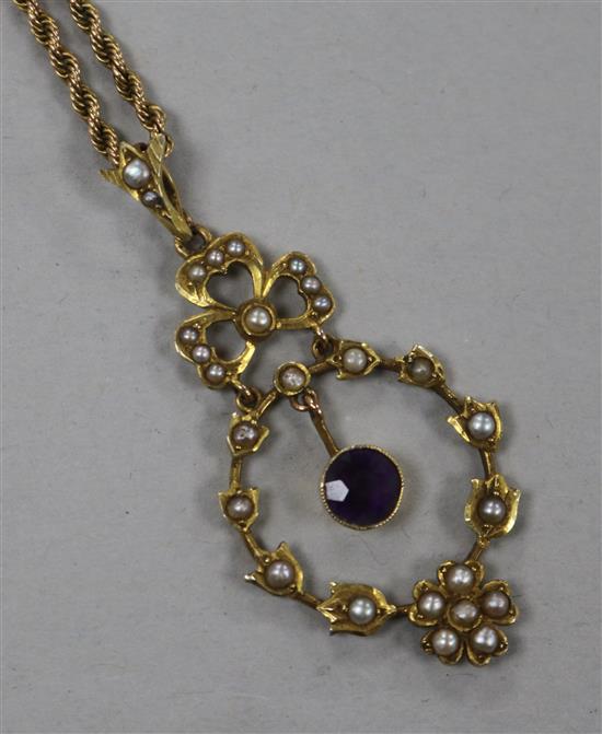An Edwardian 9ct gold seed pearl and amethyst pendant and yellow metal rope twist chain, pendant 5cm.